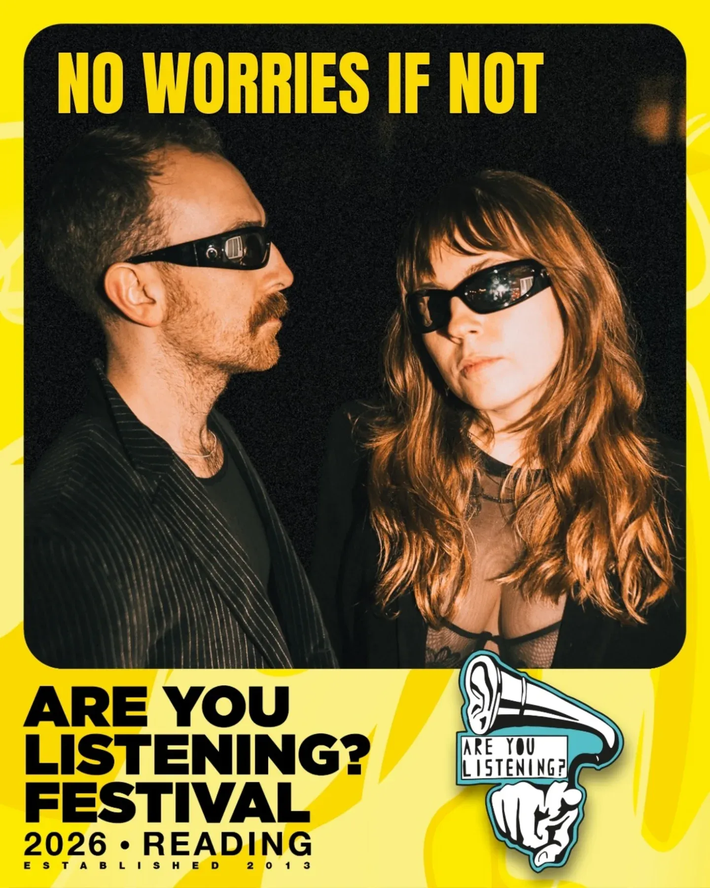 The festival's artist announcement: a flash-lit photograph of the pair in dark sunglasses, looking at each other, set in a thick yellow border with the festival's ear-and-gramophone logo in the corner.